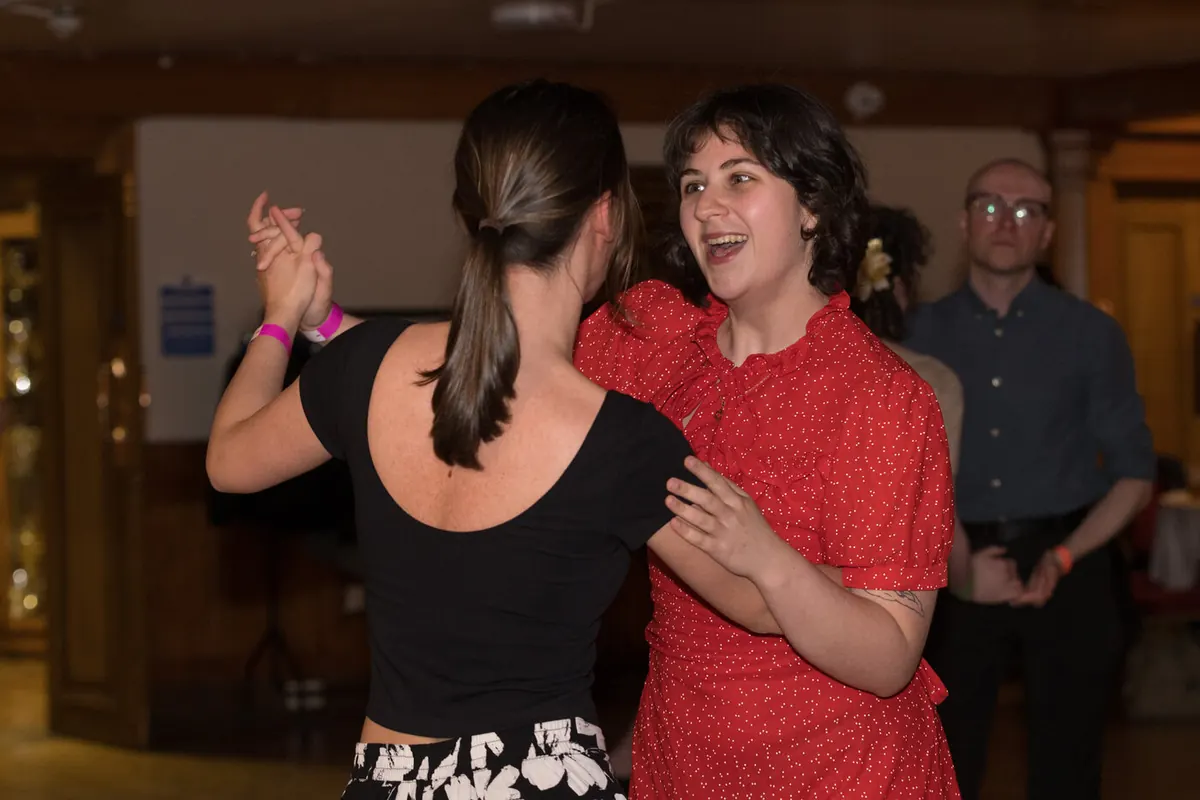 A couple sharing a laugh on the social floor